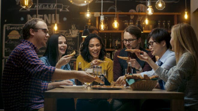 People eating pizza at restaurant