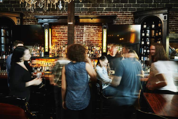 People gathered around restaurant bar