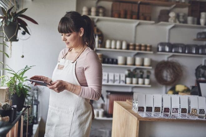 Retail shop owner looking at a tablet