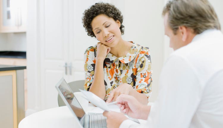 Two people reviewing paperwork