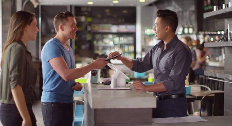 Couple redeeming gift card at shop